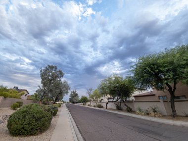 Dark blue summer monsoon sky above residential housing community in city of Phoenix, AZ
