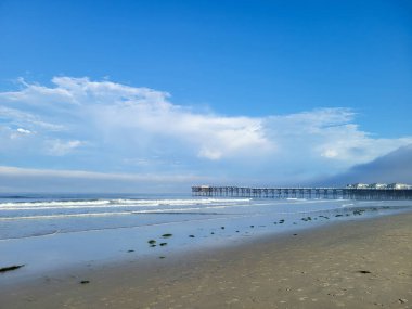 Empty Pacific Beach in the early morning with a view of historical Crystal Pier in the distance, San Diego, Southern California clipart