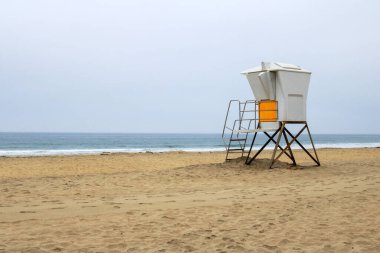 Empty South Mission beach with lonely lifeguard tower in the morning ocean fog, San Diego, California clipart