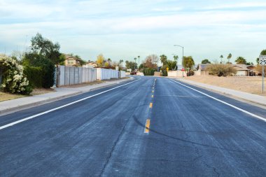 Deep dark colored road after recent resurfacing of its top layer, Phoenix, Arizon clipart