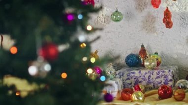 Yeni yıl gecesinde dalda asılı duran eşkenar dörtlü cam top. Noel ağacında eski oyuncaklar. Şenlikli bir gece için yakın plan dekorasyon. Arkaplanda renkli ışıklar yanıp sönüyor.