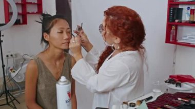 cosmetics and work as a stylist and makeup artist, women paint lips, eyes, face,