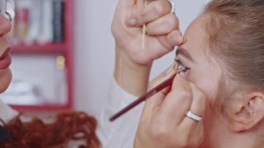 cosmetics and work as a stylist and makeup artist, women paint lips, eyes, face,