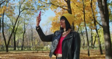 Dağlardaki genç kadın gezgin video bağlantısıyla iletişim kuruyor. Z kuşağı yolculuğu.