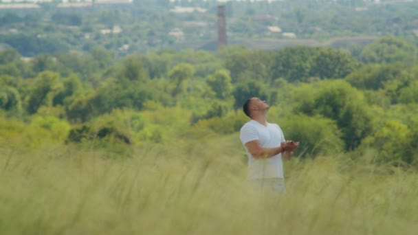 Unter Freiem Himmel Greift Ein Junger Mann Auf Einem Feld — Stockvideo