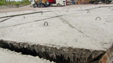İnşaat alanında metal kancalı beton levhalar. Endüstriyel materyaller inşaat ve altyapı projeleri için hazırlandı.