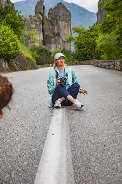 Stock image Female Photographer with Black Camera Capturing Unique Location in Meteora, Greece