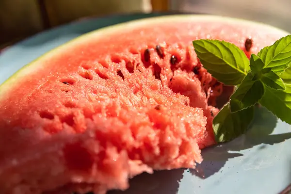 stock image Red Watermelon Flesh and Slices on a Blue Plate with a Green Mint Sprig  Fresh and Colorful Summer Treat