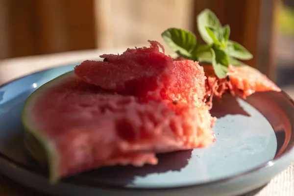 stock image Red Watermelon Flesh and Slices on a Blue Plate with a Green Mint Sprig  Fresh and Colorful Summer Treat