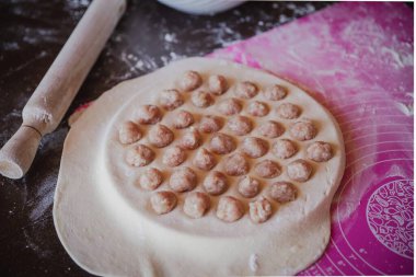 Ev yapımı hamur köfteleri pişirme süreci: yuvarlak bir kalıpta çiğ köfte, hamur işi, ulusal mutfak.