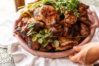 Grilled Meat Assortment with Fresh Herbs on a Plate, Close-Up clipart