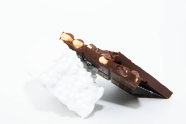 Chocolate bar with hazelnuts on a white background clipart