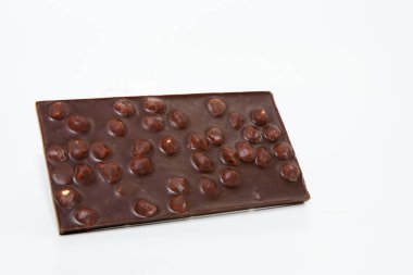 Chocolate bar with hazelnuts on a white background clipart