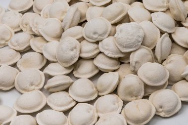 Beyaz arka planda donmuş ev yapımı hamur tatlısı, yemek pişirmek için geleneksel pelmeni