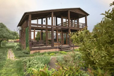 Eko ahşap ev, büyük cam pencereler ve kırsal alanda bahar leylak çalıları.