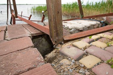 Fırtına, yıkım ve doğal afet kavramı, göldeki kırık ahşap iskele.