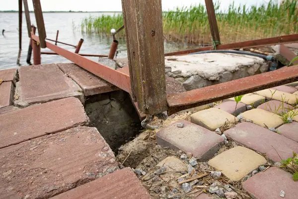 Fırtına, yıkım ve doğal afet kavramı, göldeki kırık ahşap iskele.