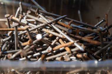 Güneş ışığı, inşaat ve onarım konseptinde karton yüzeyde siyah vidalar yığını