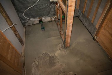 Islak beton zemin yenilenen ahşap binanın içine yeni döküldü.