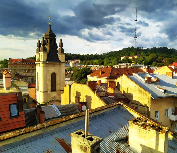 Roof top view in Lviv, Ukraine. Red tile roofs of old houses from a birds eye view. The architecture of Old Europe. Cloudy sky over the center of the medieval city.