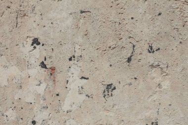 Grunge dokuyu kapat. Beton duvar arka planı. Kirli taş yüzey, eski bir duvarın parçası. Durgun bej renklerinde ayrıntılı arkaplan.
