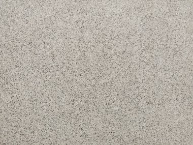 Tahıllı bej duvar dokusu. Soyut arkaplan. Küçük taşlı sıva duvar. Kısa bir fotoğraf ve mesaj için yer var. Tasarımlarınıza kolayca derinlik ve organik doku ekleyin.