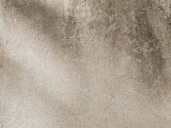 Old beige wall with shadows on it. Minimal horizontal backdrop. Abstract background, grunge concrete texture. Easily add organic depth to your designs.