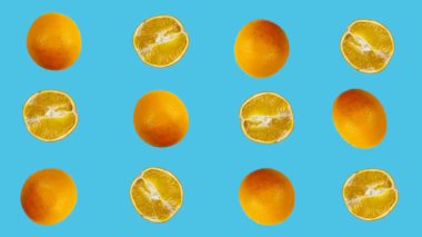 Portakallar renkli bir arka planda sallanıyor. Vejetaryen teması