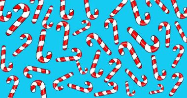 Renkli bir arka planda Noel şekeri sallanıyor.