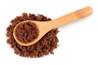 Siyah muscovado şekeri ya da beyaz arka planda izole edilmiş tahta kaşıkta Barbados şekeri. Üst Manzara. Düz yatıyordu.
