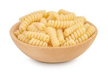 İtalyan spiral şeklinde makarna, beyaz arka planda izole edilmiş ahşap kasede Fusilli bucati makarna..