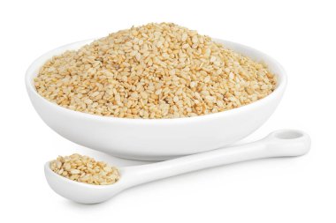 Seramik kasede susam tohumları ve beyaz arka planda izole edilmiş kaşık.