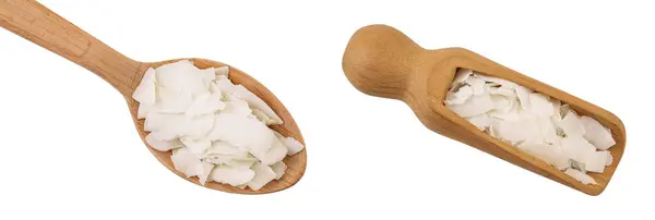 stock image Coconut flakes or chips in wooden spoon and scoop isolated on white background. Top view. Flat lay.