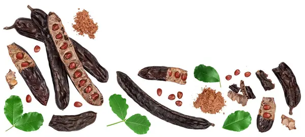 stock image Ripe carob pods and bean isolated on white background. Top view with copy space for your text. Flat lay.