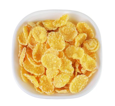 Beyaz arka planda izole edilmiş seramik kasedeki mısır gevrekleri