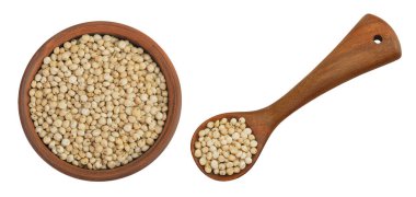 Sorghum seeds in ceramic bowl and wooden spoon isolated on white background. Top view. Flat lay clipart