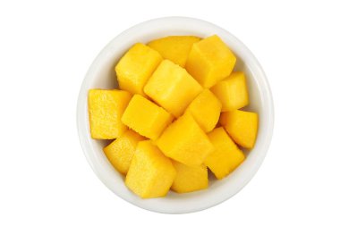 mango diced in ceramic bowl isolated on white background. Top view. Flat lay.
