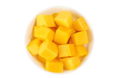 mango diced in ceramic bowl isolated on white background. Top view. Flat lay.
