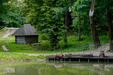 poor country rural log house cottage water shore line woods village wilderness culture of Asian region environment space with wooden pier