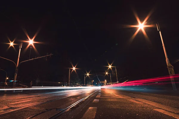 stock image city street at night with vehicles light trails