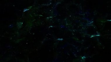 Soyut hareket arkaplanı renkli parçacıklar parlıyor. Kusursuz 4K döngü videosu.