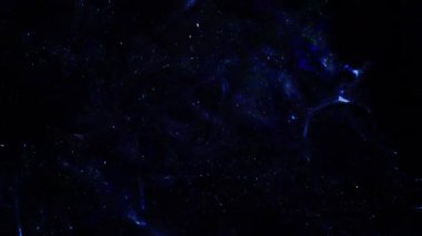 Soyut hareket arkaplanı renkli parçacıklar parlıyor. Kusursuz 4K döngü videosu.