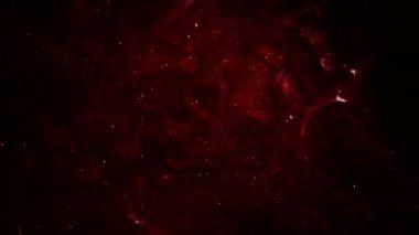 Soyut hareket arkaplanı renkli parçacıklar parlıyor. Kusursuz 4K döngü videosu.