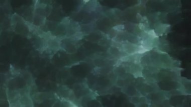 Soyut hareket arkaplanı renkli parçacıklar parlıyor. Kusursuz 4K döngü videosu.