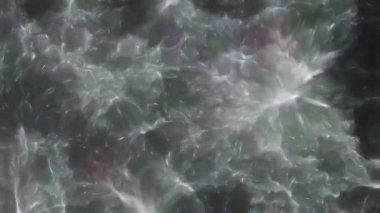 Soyut hareket arkaplanı renkli parçacıklar parlıyor. Kusursuz 4K döngü videosu.