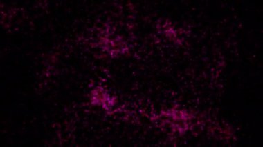 Soyut hareket arkaplanı renkli parçacıklar parlıyor. Kusursuz 4K döngü videosu.