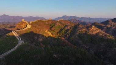 Yüksek kalite, güneş Çin Seddi 'nin kıvrımlı tepelerinden yükselirken, insan yapımı yapısal yılanlar gibi yeryüzüne yayılan 4k' lık insansız hava aracı.