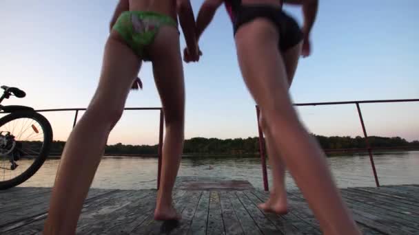 Two Little Girls Jumps Wooden Footbridge River Summer Evening — Stock Video