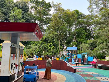 South Tangerang, Indonesia - May 10, 2024: Public children playground at Taman Kota 1 BSD public park. clipart