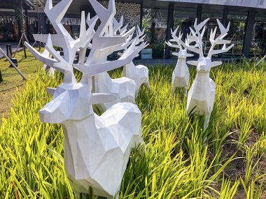 Tangerang, Indonesia - May 13, 2024: White plastic deer decoration in Indonesian Design District (IDD) located in PIK 2. Shot during day time clipart